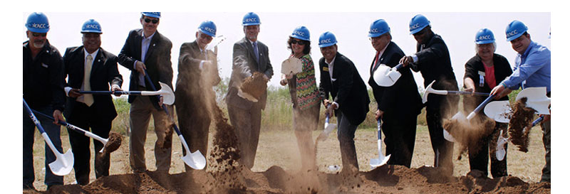 ACC employees digging earth for new campus