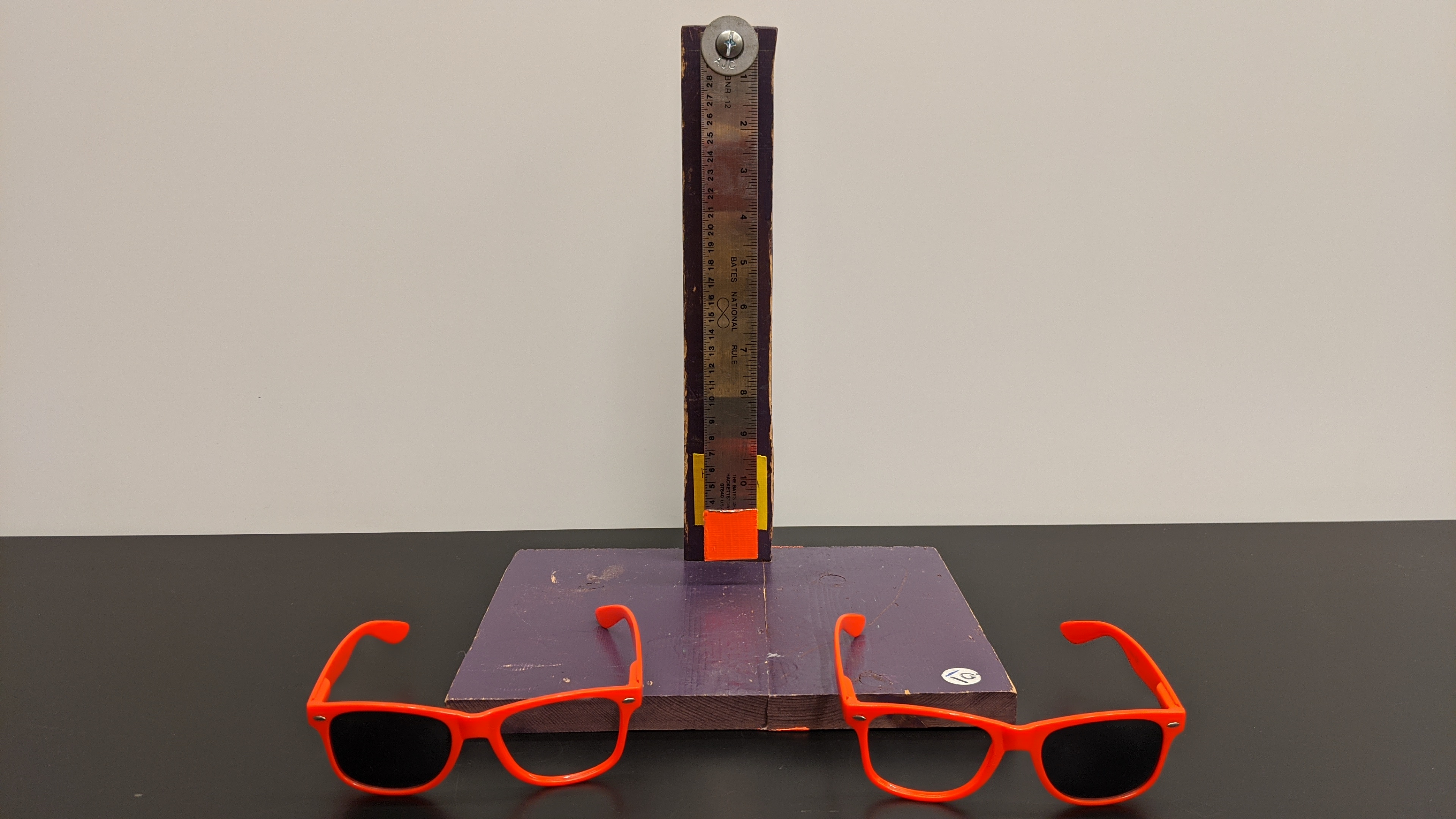 A pendulum and some sunglasses with one lens popped out