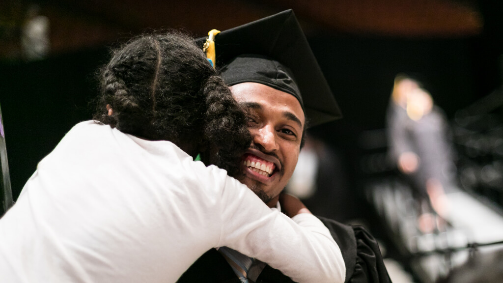 Student hugging someone at commencement