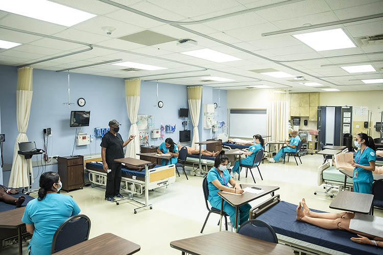 Nursing students work in a hospital setting. 