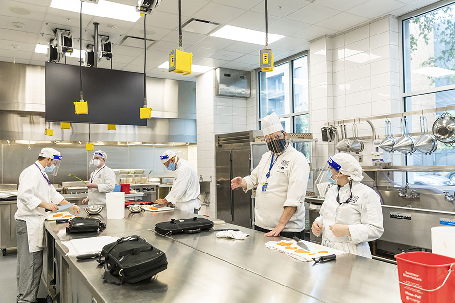 Chef David Waggoner gives feedback to Morgan B. during their first class inside one of the new commercial kitchens at the Highland Campus, Building 2000. 