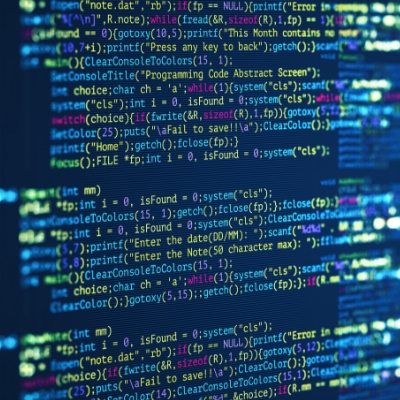 Computer screen showing code with a person in the background.