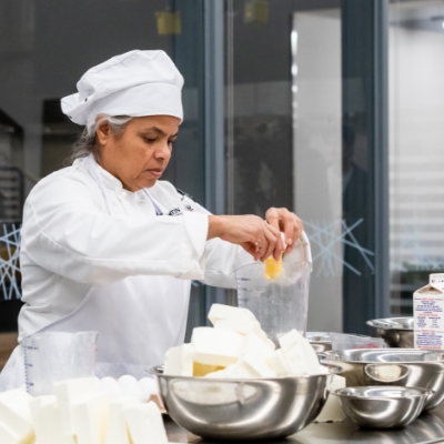 Chef preparing food in a kitchen.
