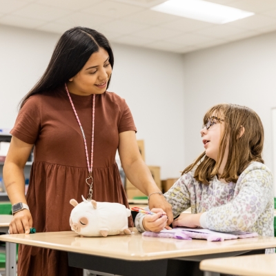 Woman and child in a classroom setting.