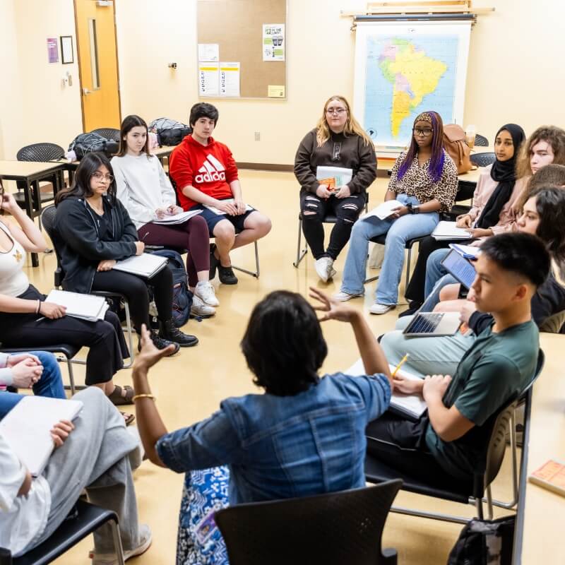 Classroom discussion with students sitting in a circle.