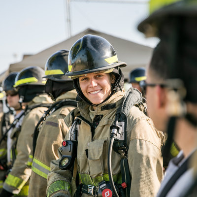 Firefighter in uniform with colleagues.